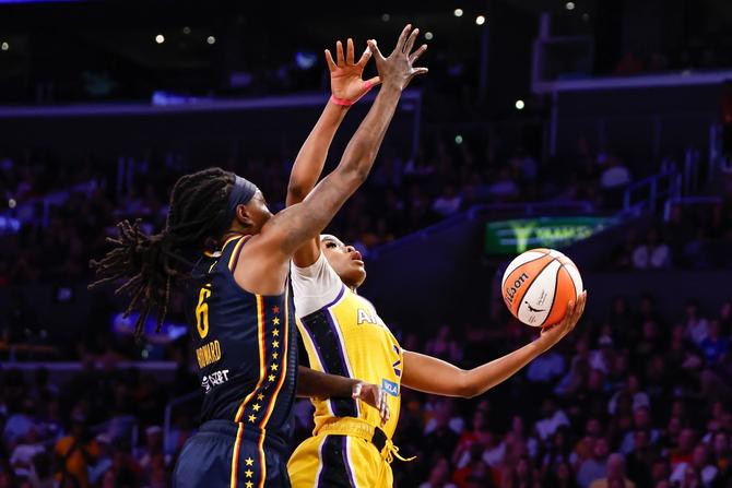 Natasha Howard going up to block Rickea Jackson's shot