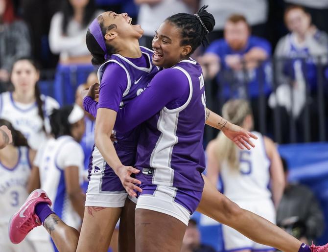 Kansas State Wildcats Temira Poindexter and Kennedy Taylor embrace in celebration after upsetting the Kentucky Wildcats.