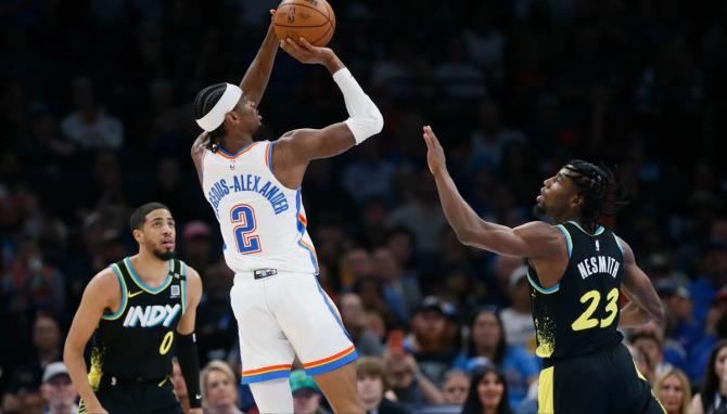 The OKC Thunder’s Shai Gilgeous-Alexander is defended by Indiana Pacer Aaron Nesmith.