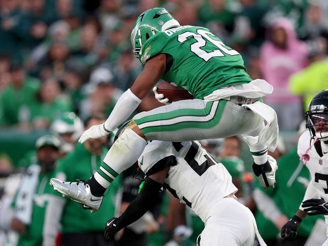 Saquon Barkley hurdling backwards over another player