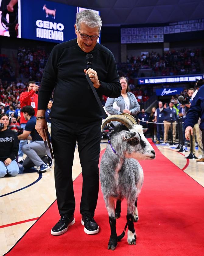 UConn coach Geno Auriemma poses with a goat after winning his NCAA basketball record 1,217th career game