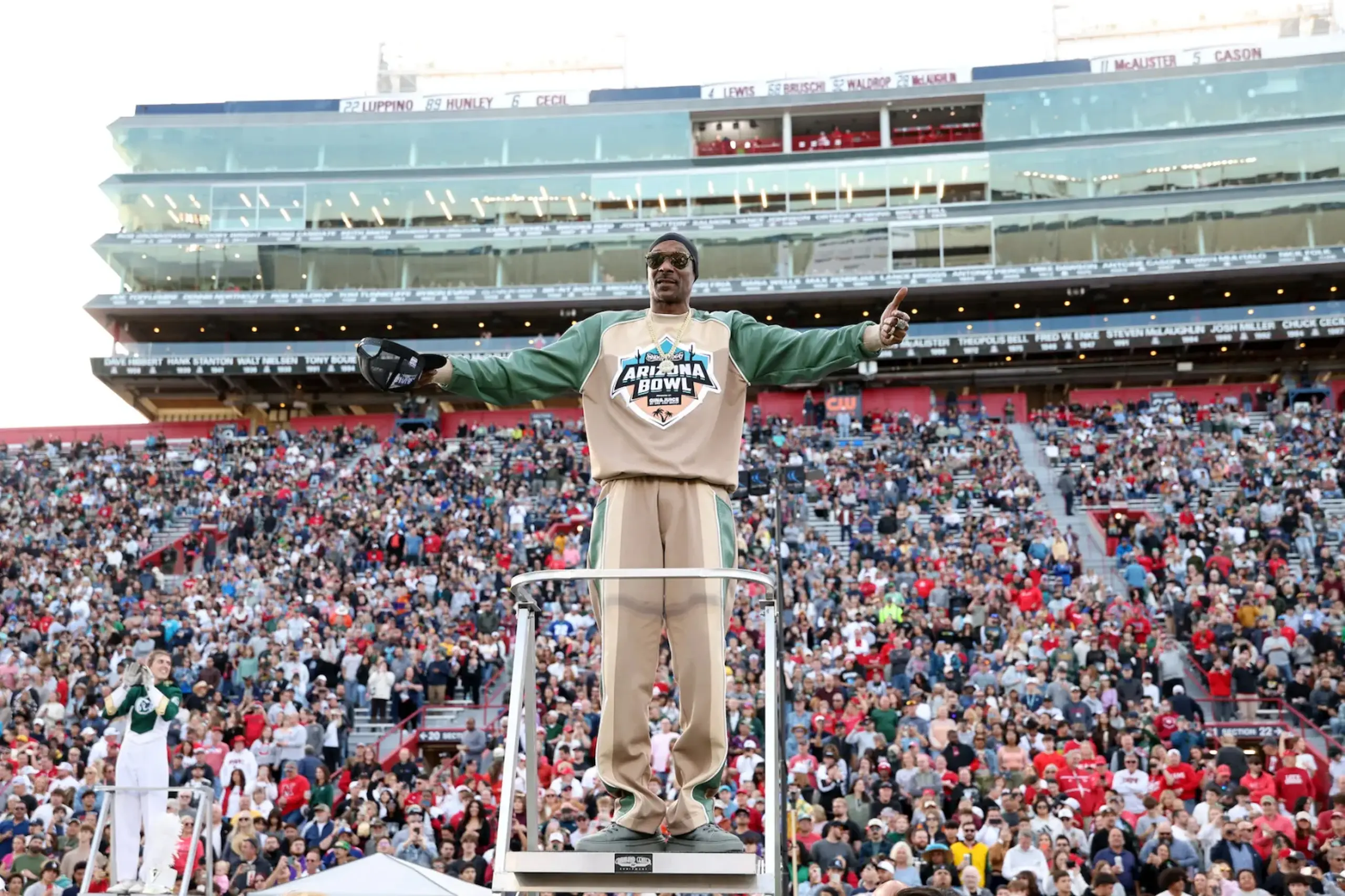 Snoop Dogg conducts the marching band at the Snoop Dogg Arizona Bowl.