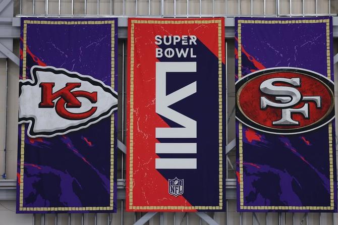 Banners for both the San Francisco 49ers and Kansas City Chiefs hang on either side of a Super Bowl LVIII banner.
