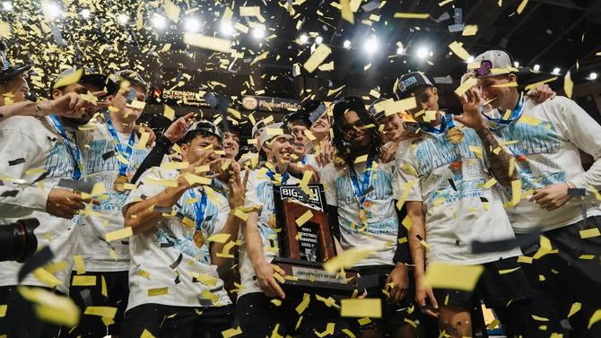 Members of the Idaho men’s basketball hold the Big Sky championship trophy as confetti falls.