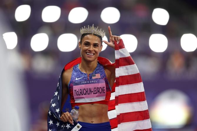 Sydney McLaughlin-Levrone of Team United States celebrates winning the gold medal with the new World Record by wearing a crown after competing in the Women's 400m Hurdles Final on day thirteen of the Olympic Games Paris 2024 at Stade de France on August 08, 2024 in Paris, France.