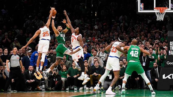 NY Knicks Mikal Bridges and OG Anunoby defend Boston's Jayson Tatum.