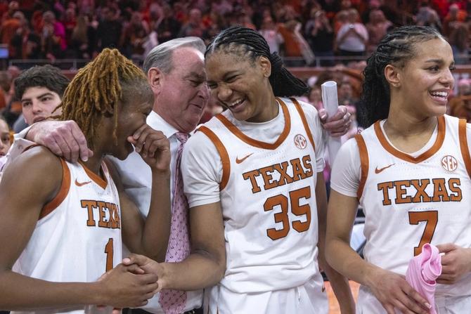 Guard Bryanna Preston, head coach Vic Schaefer, forward Madison Booker, and guard Jordan Lee celebrate Texas women’s basketball’s win over LSU.
