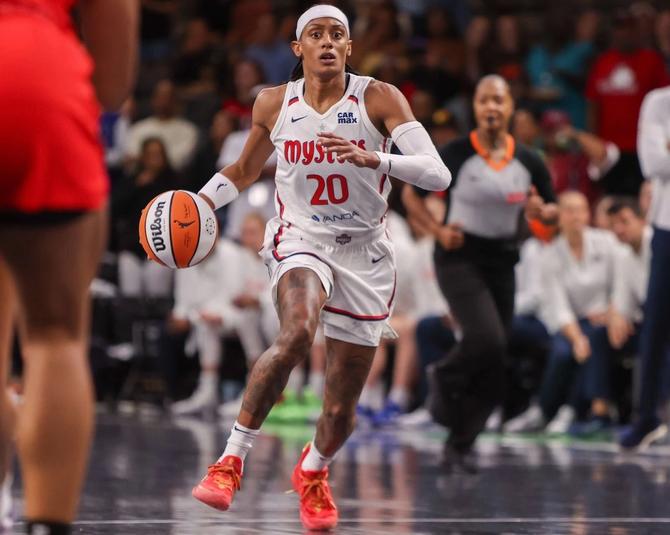 Brittney Sykes, then a member of the Washington Mystics, dribbles the ball up the court.