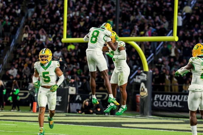Members of the Oregon football team celebrate during their win over Purdue.