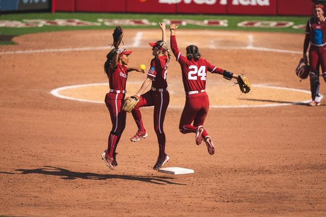 No. 2–seed Oklahoma softball players dance around second base during a Regional matchup last weekend.