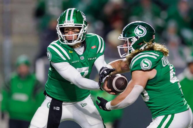 Saskatchewan Roughriders quarterback Trevor Harris hands the ball off to running back A.J. Ouellette.