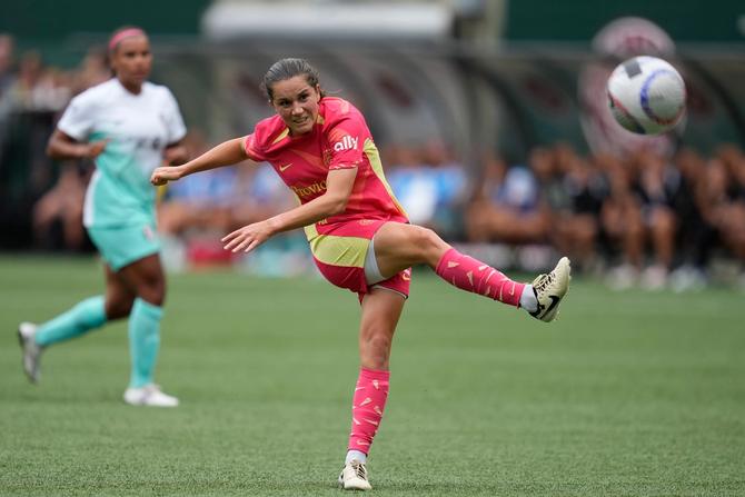 Jessie Fleming follows through after kicking the ball during a game.