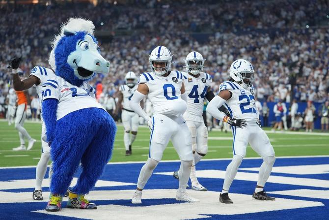 Indianapolis Colts safety Cam Bynum (0) celebrates an interception with the Indianapolis Colts mascot Blue and cornerback Kenny Moore II (23) during the second half an NFL football game against the Denver Broncos