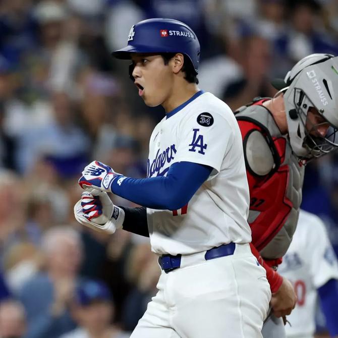 Shohei Ohtani celebrates after hitting a two-run home run in the sixth inning against the Reds