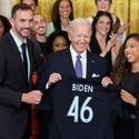 President Joe Biden poses with a NJ/NY Gotham jersey.