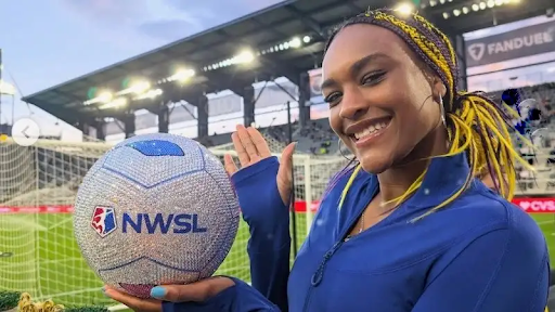 Aaliyah Edwards poses with a custom crystal-encrusted ball at an NWSL match