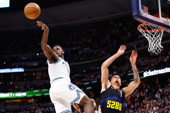 Minnesota Timberwolves Anthony Edwards passes the ball.
