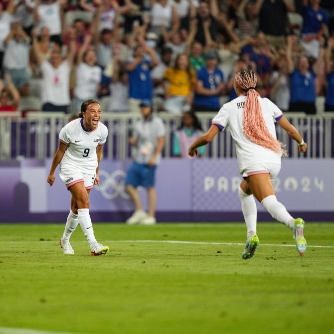 USWNT forwards Mallory Swanson and Trinity Rodman celebrate a goal.