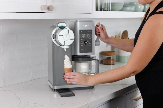 A person making an ice cream cone on a Ninja Swirl by CREAMI machine