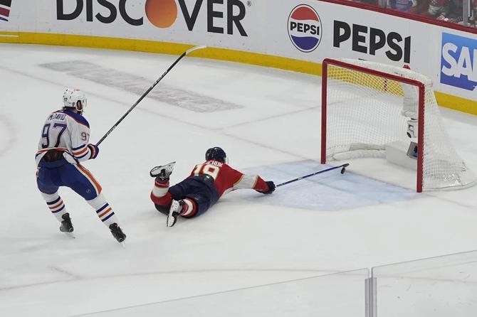 Florida Panthers left winger Matthew Tkachuk saves a shot in front of Edmonton Oilers center Connor McDavid in Game 5 of the Stanley Cup Final.