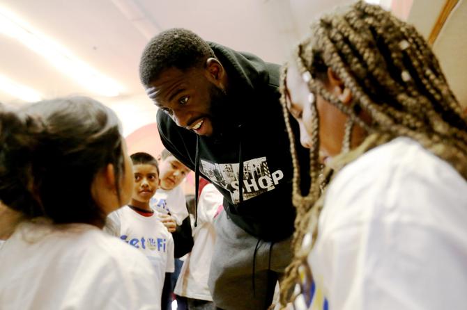 Golden State Warriors' Draymond Green interacts with kids from the after school program during a visit at Manzanita SEED Elementary School in Oakland, Calif., on Wednesday, Jan. 30, 2019. The Warriors, in partnership with Kaiser Permanente and Playworks hosted a Get Fit Time-Out to promote the importance of physical activity, mindfulness and healthy nutrition.