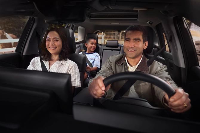 Family smiling inside a Toyota RAV4