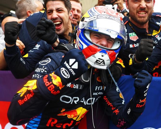 Red Bull’s Max Verstappen fist pumps as he celebrates his race win with his team.