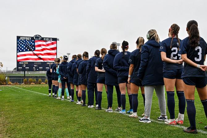 The Penn State women’s soccer team lines up for the National Anthem before a game.
