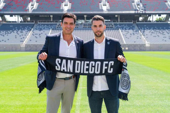 San Diego FC CEO Tom Penn, left, and team sporting director Tyler Heaps stand on the pitch at Snapdragon Stadium, where the team will play starting this year.