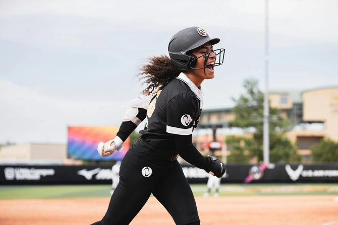 Athletes Unlimited softball player McKenzie Clark shouts triumphantly as she takes her base.