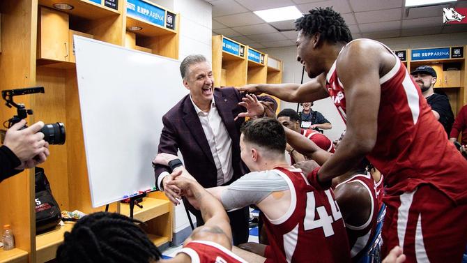 Arkansas head basketball coach John Calipari celebrates with his players after defeating No. 12 Kentucky.