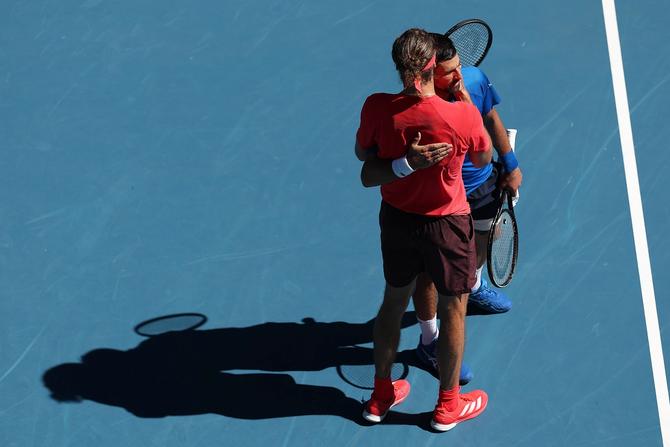 Novak Djokovic of Serbia is embraced by Alexander Zverev of Germany after retired from the Men's Singles Semifinal during day 13 of the 2025 Australian Open