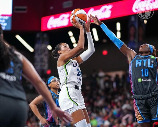 Minnesota Lynx superstar Napheesa Collier shoots the ball over a defender.