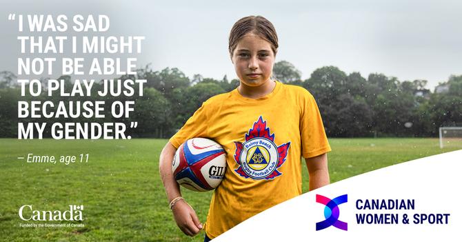 Emme holding a soccer ball on a field