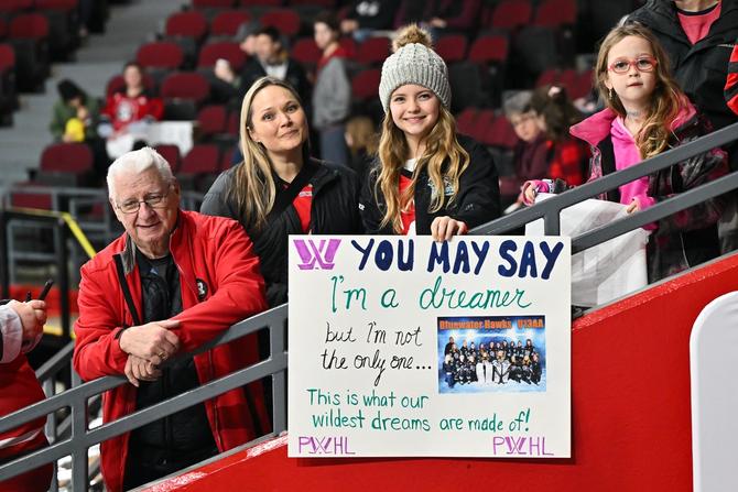 A young spectator holds up a sign ahead of the Professional Women's Hockey League (PWHL) game between Montreal and Ottawa at The Arena at TD Place on January 2, 2024 in Ottawa, Ontario, Canada.