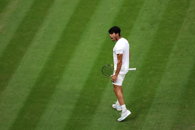 Carlos Alcaraz of Spain celebrates winning match point against Tommy Paul of United States in the Gentlemen's Singles Quarter Final match during day nine of The Championships Wimbledon 2024