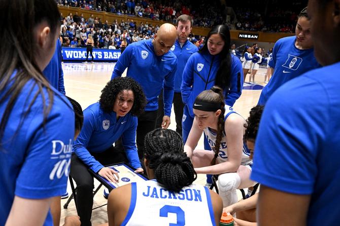 Duke women’s basketball coach Kara Lawson huddles with her team