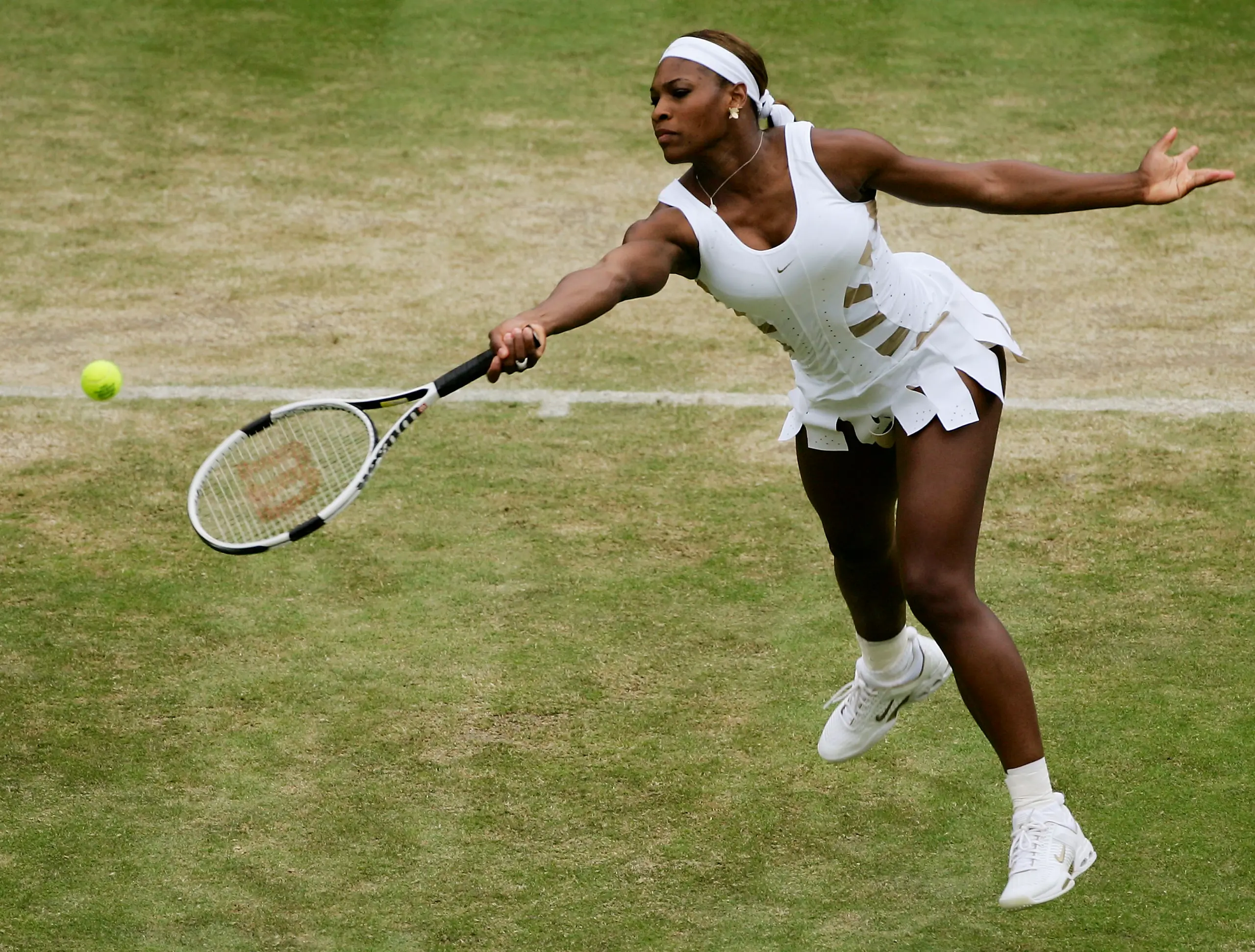 Serena Williams hitting a tennis ball during Wimbledon