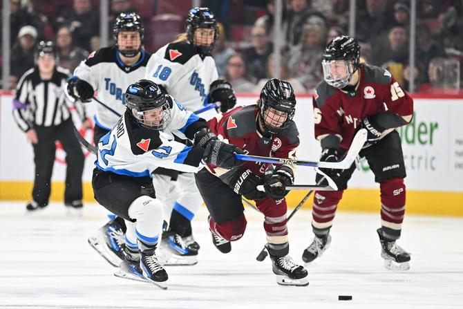 Brittany Howard #41 of Toronto and Marie-Philip Poulin #29 of Montréal skate after the puck during the third period in the PWHL game