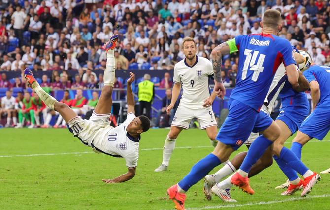 Jude Bellingham of England scores his team's first goal with a bicycle kick.