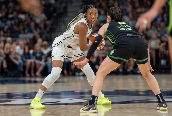 The Golden State Valkyries’ Kayla Thornton holds the ball while Minnesota Lynx Bridget Carleton defends.
