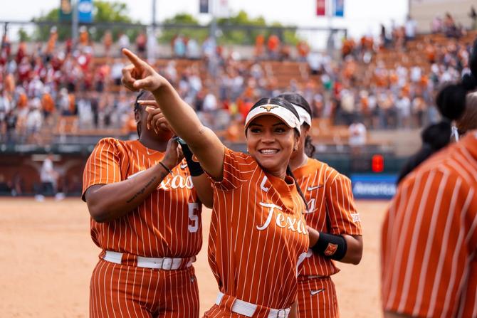 No. 1 Texas softball second baseman Alyssa Washington smiles and points to the stands as her Longhorns celebrate their Sunday win over No. 2 Oklahoma.
