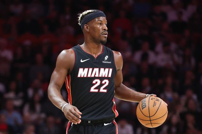 Former Miami Heat superstar Jimmy Butler dribbles the ball up the court.