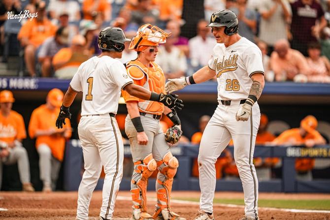 Vanderbilt baseball freshman Braden Holcomb low-fives teammate Matthew Polk as they both reach home base following Holcomb’s home run during their May 25th game against Tennessee.