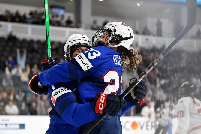 Lacey Eden of the United States celebrates scoring a goal with Hannah Bilka.