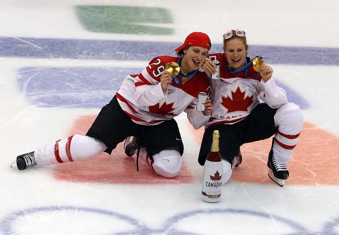 Marie-Philip Poulin #29 and Tessa Bonhomme #25 of Canada celebrate winning the gold medal with a beer and a cigar following their team's 2-0 victory during the ice hockey women's gold medal game between Canada and USA on day 14 of the Vancouver 2010 Winter Olympics at Canada Hockey Place on February 25, 2010 in Vancouver, Canada.