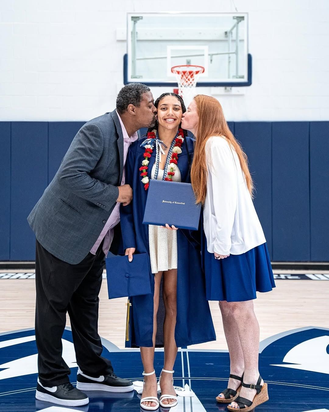 Azzi Fudd's parents embrace her following her graduation.