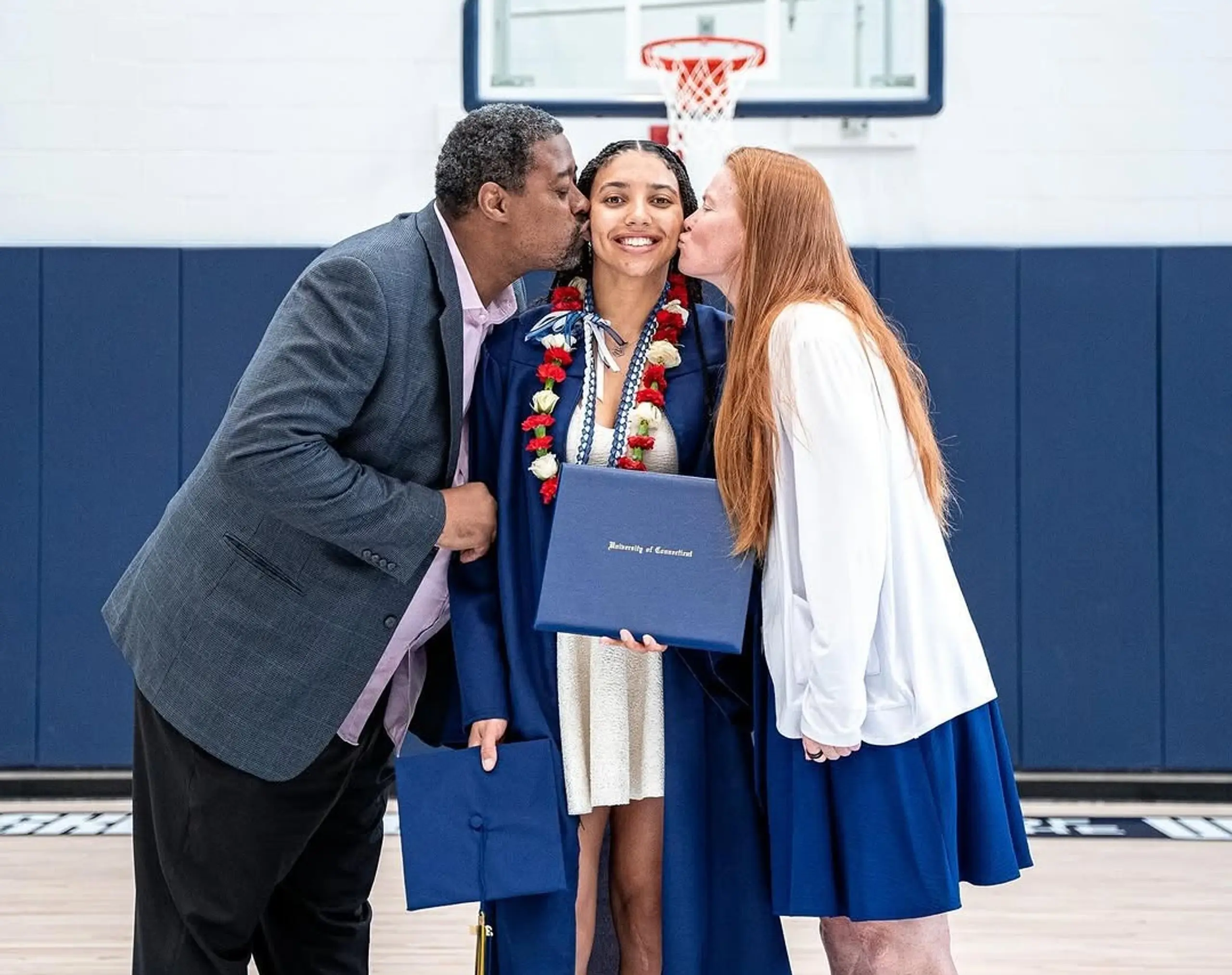 Azzi Fudd’s parents embrace her following her graduation.