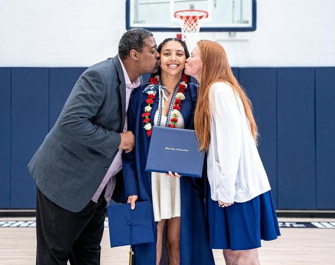 Azzi Fudd's parents embrace her following her graduation.