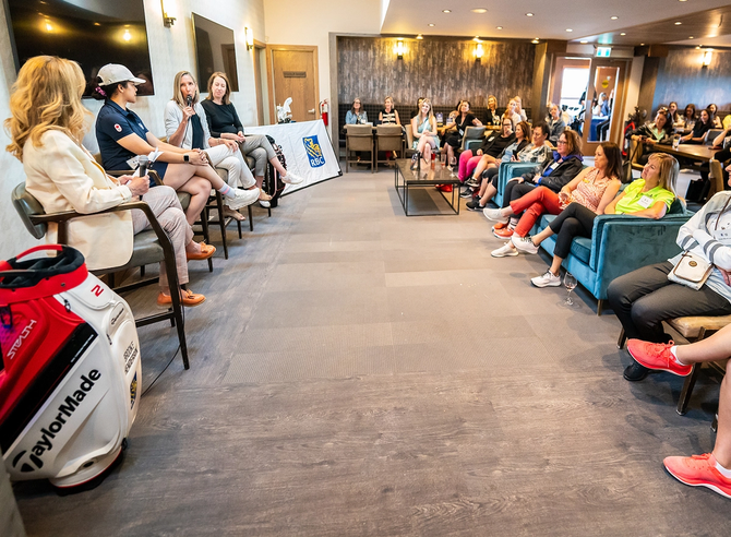 Golfers speaking to a group of people at an event